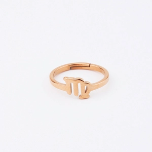 Detailed view of Virgo zodiac sign engraved on a rose gold stainless steel ring