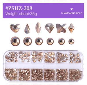 Macro detail of 12-slot storage box with assorted champagne gold glass nail art rhinestones