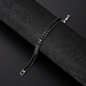 Detail of luxury tennis bracelet featuring rectangular black zircons in silver setting