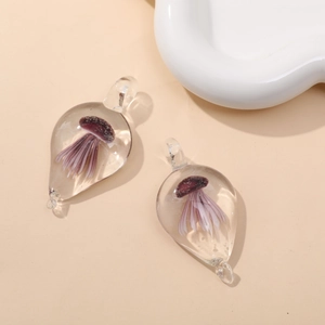 Macro shot of a teardrop-shaped glass pendant with a purple jellyfish interior design