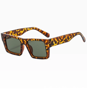 Detail of tortoise shell square frame sunglasses with dark green lenses from a side angle