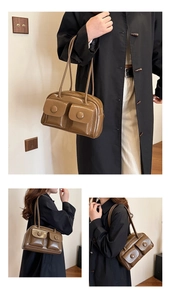 Close-up of caramel brown leather shoulder bag with two front flap pockets and vintage buckled strap