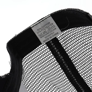 Close-up of the cotton-polyester blend fabric and care label on the black trucker hat