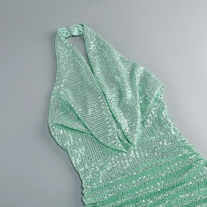 Close-up of mint green sequins on a halter neck floor-length evening dress fabric