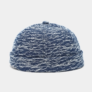Detail of blue and white textured denim fabric on a vintage brimless docker hat