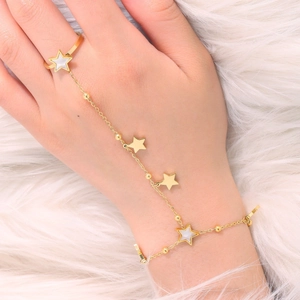 Elegant gold stainless steel ring bracelet with five-pointed star charms on white fur