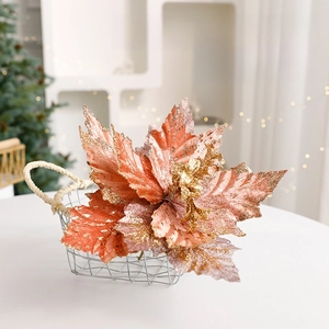 Rose gold Christmas flower with glitter in a white basket for festive holiday decoration