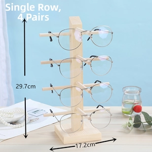 Detailed view of single-row pine wood eyewear display stand holding four pairs of glasses