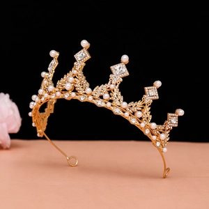 Detailed view of golden baroque crown with white pearls and square cubic zirconia stones