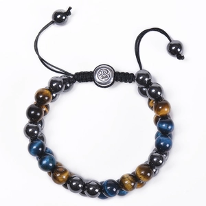 Detail of double-layer beaded bracelet with blue tiger eye stone and Om symbol charm