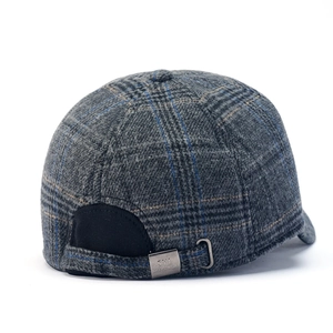 Detail of plaid wool baseball cap with adjustable strap and engraved metal buckle