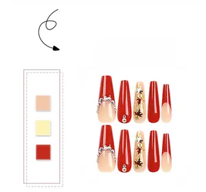 Detail of red and nude coffin press-on nails with gold maple leaf and rhinestone accents