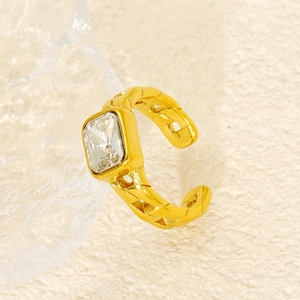 Detailed close-up of a gold chain-design ear cuff featuring a square zircon on fabric