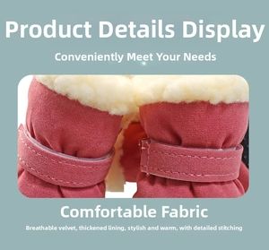 Detail of pink pet snow boots featuring warm thickened faux fur lining and velcro strap