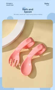 Detail of pink ergonomic curved baby spoon and fork set for self-feeding training