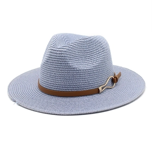Detail of light blue straw fedora hat featuring a brown leather band and gold metal buckle