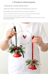 Detail of Christmas ornament featuring red bells, pine cones and Merry Christmas ribbon