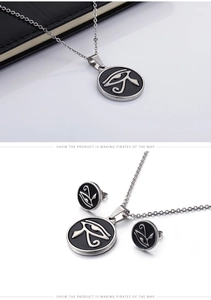 Macro detail of silver Tree of Life and Eye of Horus coin necklace and earring set
