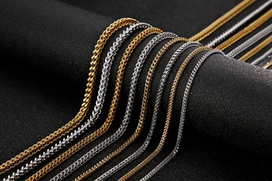 Detailed macro view of gold and silver snake bone chain necklaces in various widths