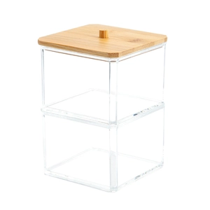Detail of multi-layer clear acrylic storage box with natural bamboo lid and round handle
