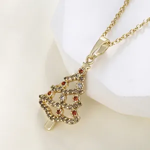 Golden Christmas tree pendant necklace with colorful zircons on a white display stand