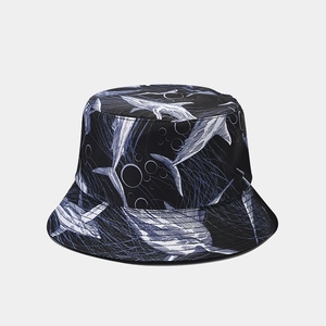 Detail of a navy blue bucket hat featuring an all-over white shark print and sea patterns