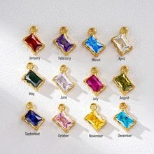 Detailed grid of twelve monthly birthstone pendants in gold stainless steel frames