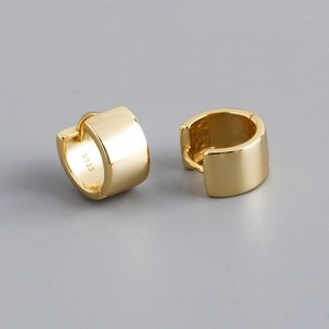 Close-up of golden S925 sterling silver hoop earrings with a polished wide surface