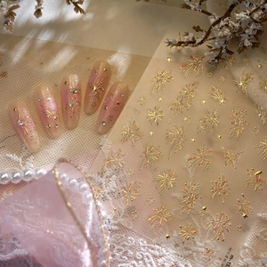 Elegant fireworks nail art stickers with gold gradient texture on pink ombre nails
