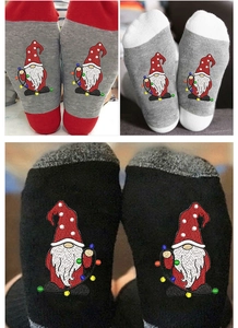 Detail view of festive Christmas gnome crew socks in red, grey and black cotton knit