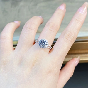 Macro shot of a 925 sterling silver ring with round moissanite and pavé diamond band