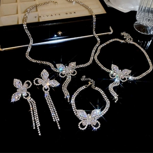 Detailed view of silver butterfly jewelry set with sparkling rhinestones and tassels
