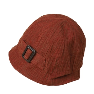 Linen bucket hat in caramel brown featuring a textured vertical fold and side buckle