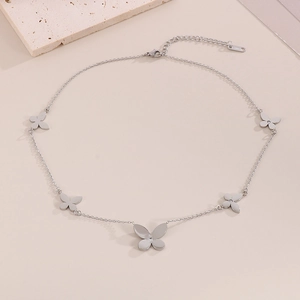 Detailed close-up of a silver butterfly necklace featuring a clear crystal pendant inlay
