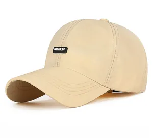 Close-up of quick-dry baseball cap featuring a black rubber patch and stitching