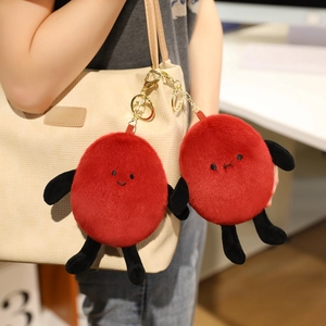 Funny plush peanut bag charms in red with cute expressions and gold keychains