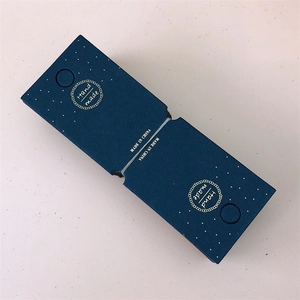 Close-up of blue paper jewelry tags with gold dots and Hand Made foil stamping