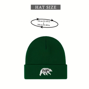 Detail of dark green knit beanie with white Papa polar bear embroidery and size chart