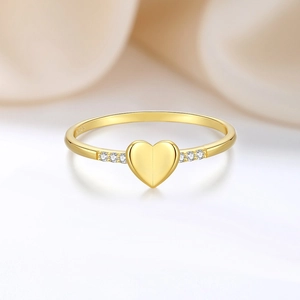 Elegant gold S925 sterling silver heart ring with side diamonds on soft beige background