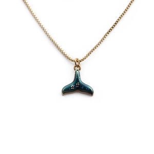 Elegant gold-plated fishtail necklace with dark teal enamel pendant on white background