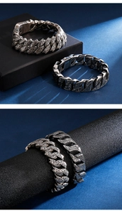 Detail of vintage carved stainless steel Cuban bracelet with antique silver finish texture