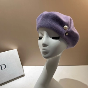 Elegant purple wool beret with white pearl and gold bead accent on a model head