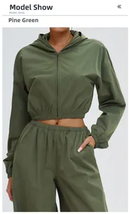 Detail of pine green lightweight hooded sports jacket and matching pants set for women