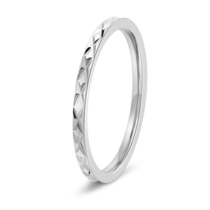 Macro shot of silver titanium steel ring with textured diamond-cut pattern and high finish