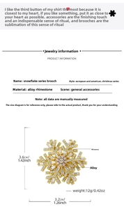Detailed view of gold snowflake brooch with inlaid rhinestones measuring 3.6cm by 3.2cm