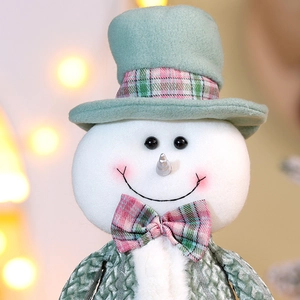 Macro shot of a mint green plush Christmas snowman with detailed knit texture and soft lighting