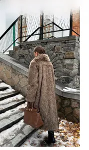 Rear view of brown faux fur long coat showing rich texture on winter street backdrop
