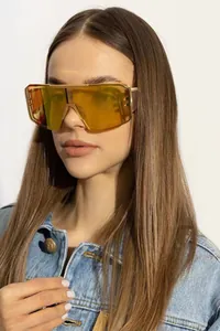 Detail view of gold steampunk sunglasses with yellow lenses and mesh texture