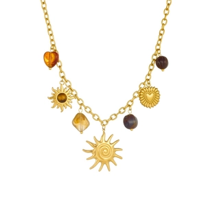 Gold vintage necklace featuring sun and heart pendants with amber beads on white background