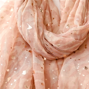 Close-up of pink lightweight scarf with rose gold foil dots and sheer fabric texture